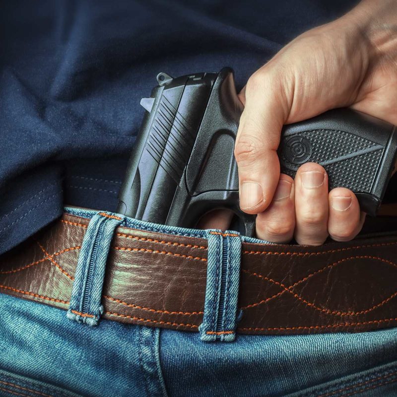 Man Hiding a Gun
